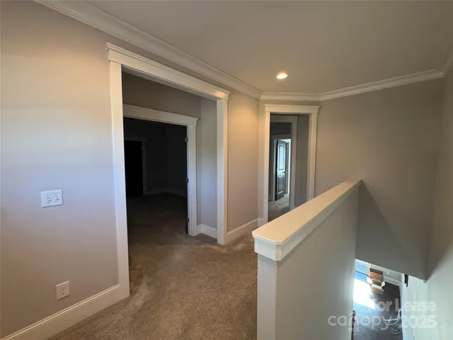 an empty room with a window and a ceiling fan