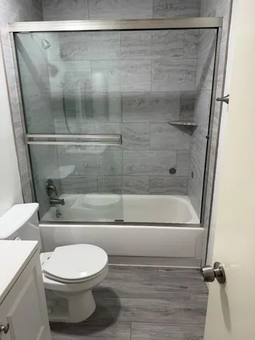 a bathroom with a toilet and a shower