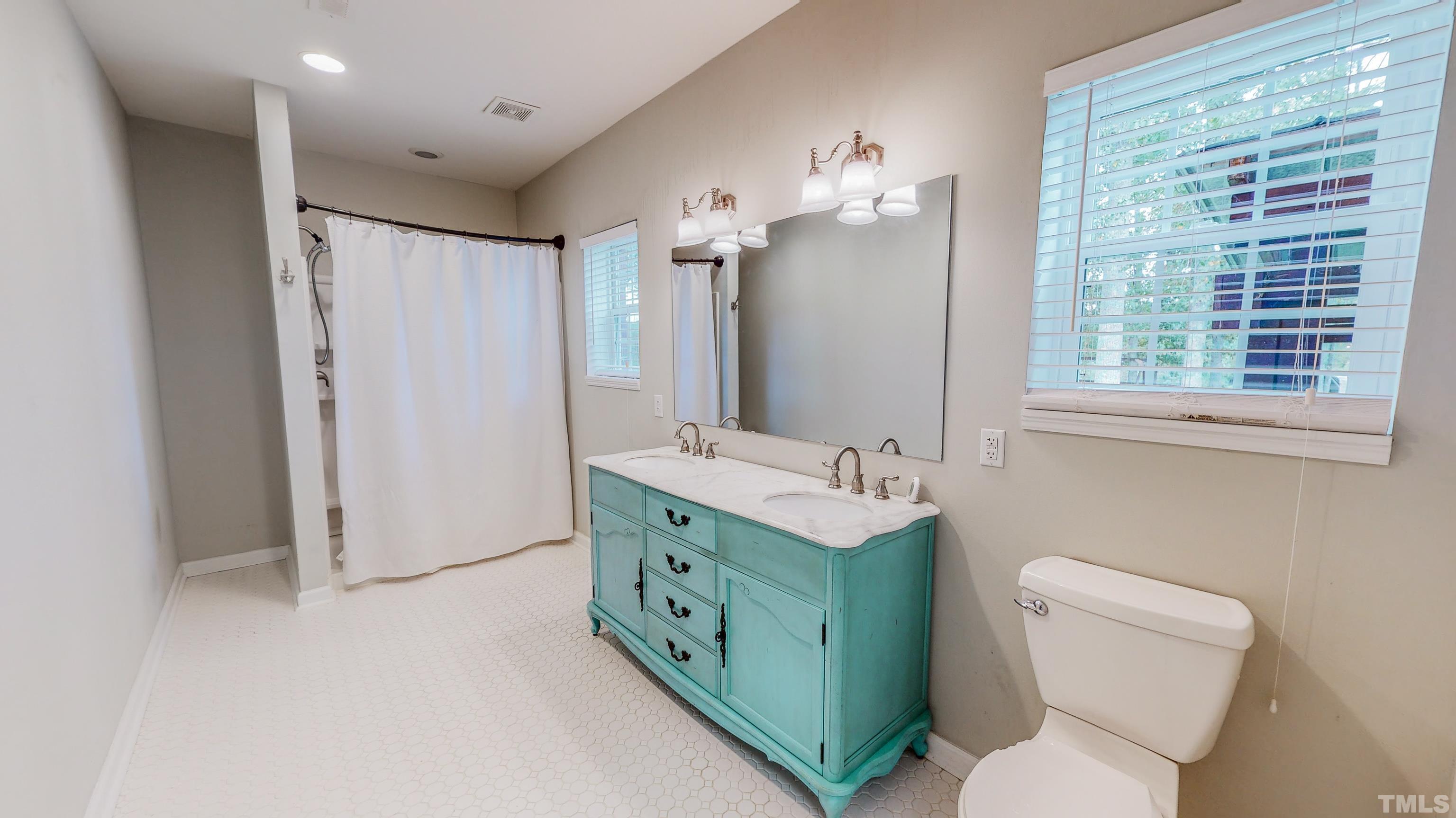 3920 Oxford Road Roxboro, NC 27574 - Photo 12 of 30 a bathroom with a toilet sink and mirror