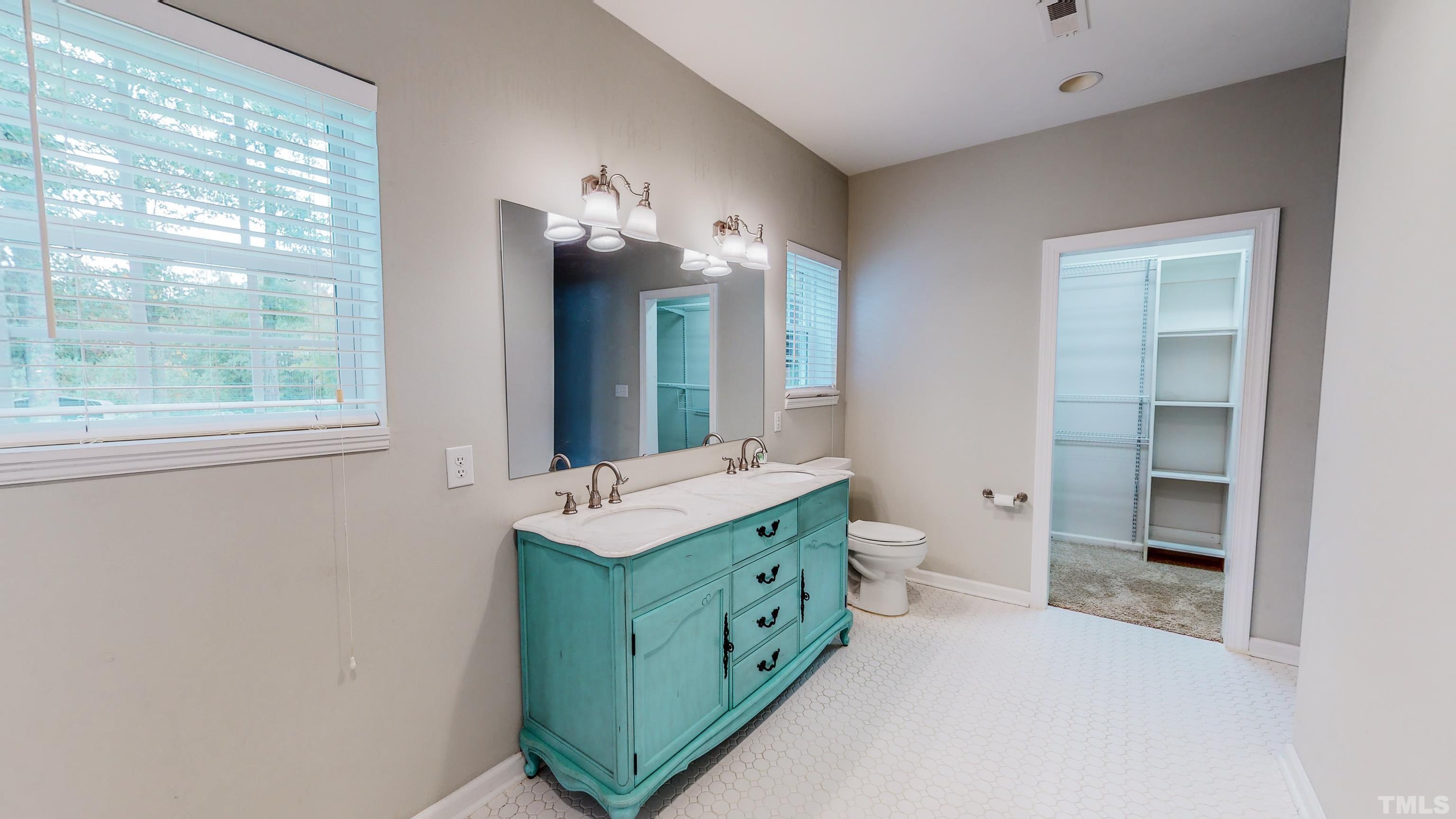 3920 Oxford Road Roxboro, NC 27574 - Photo 13 of 30 a bathroom with a double vanity sink toilet and mirror