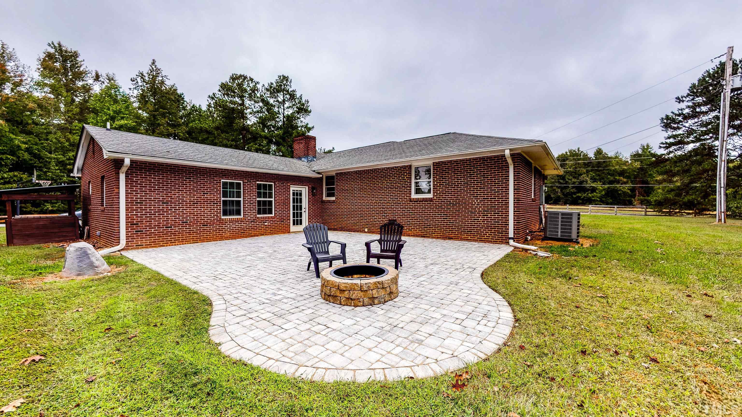 3920 Oxford Road Roxboro, NC 27574 - Photo 15 of 30 a backyard of a house with yard fire pit and outdoor seating