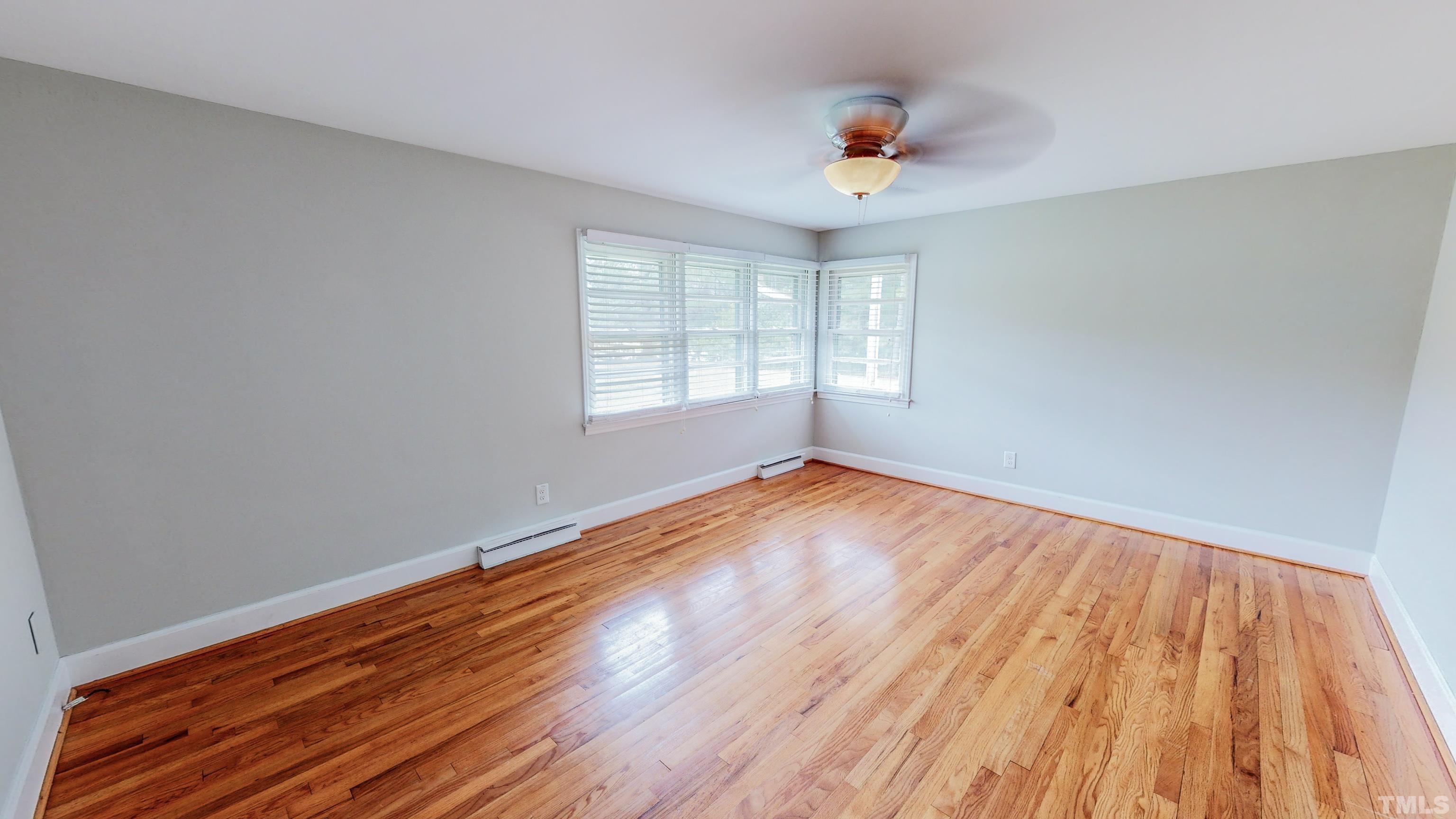 3920 Oxford Road Roxboro, NC 27574 - Photo 17 of 30 an empty room with wooden floor and windows