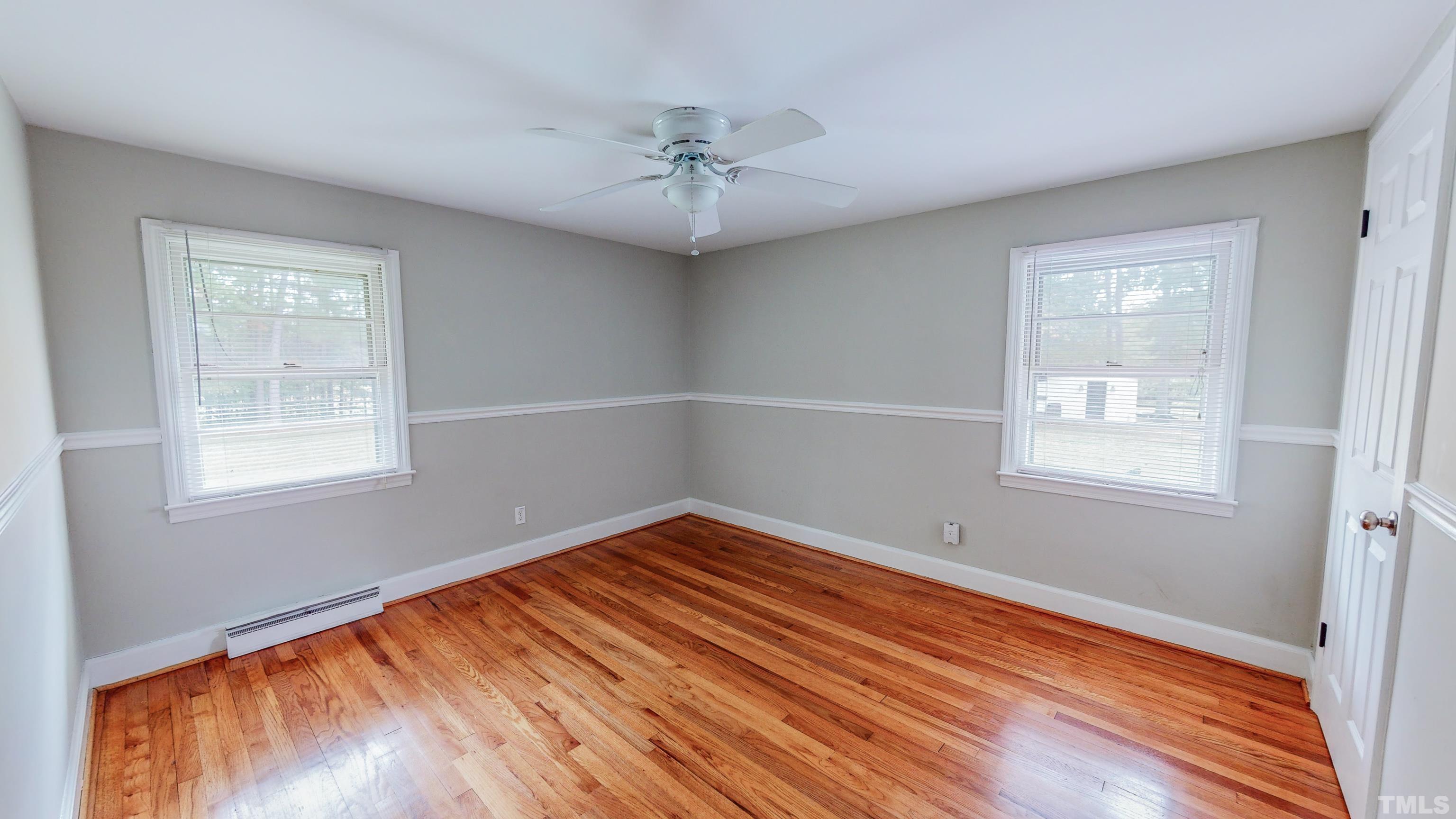3920 Oxford Road Roxboro, NC 27574 - Photo 19 of 30 a view of an empty room with wooden floor and a window