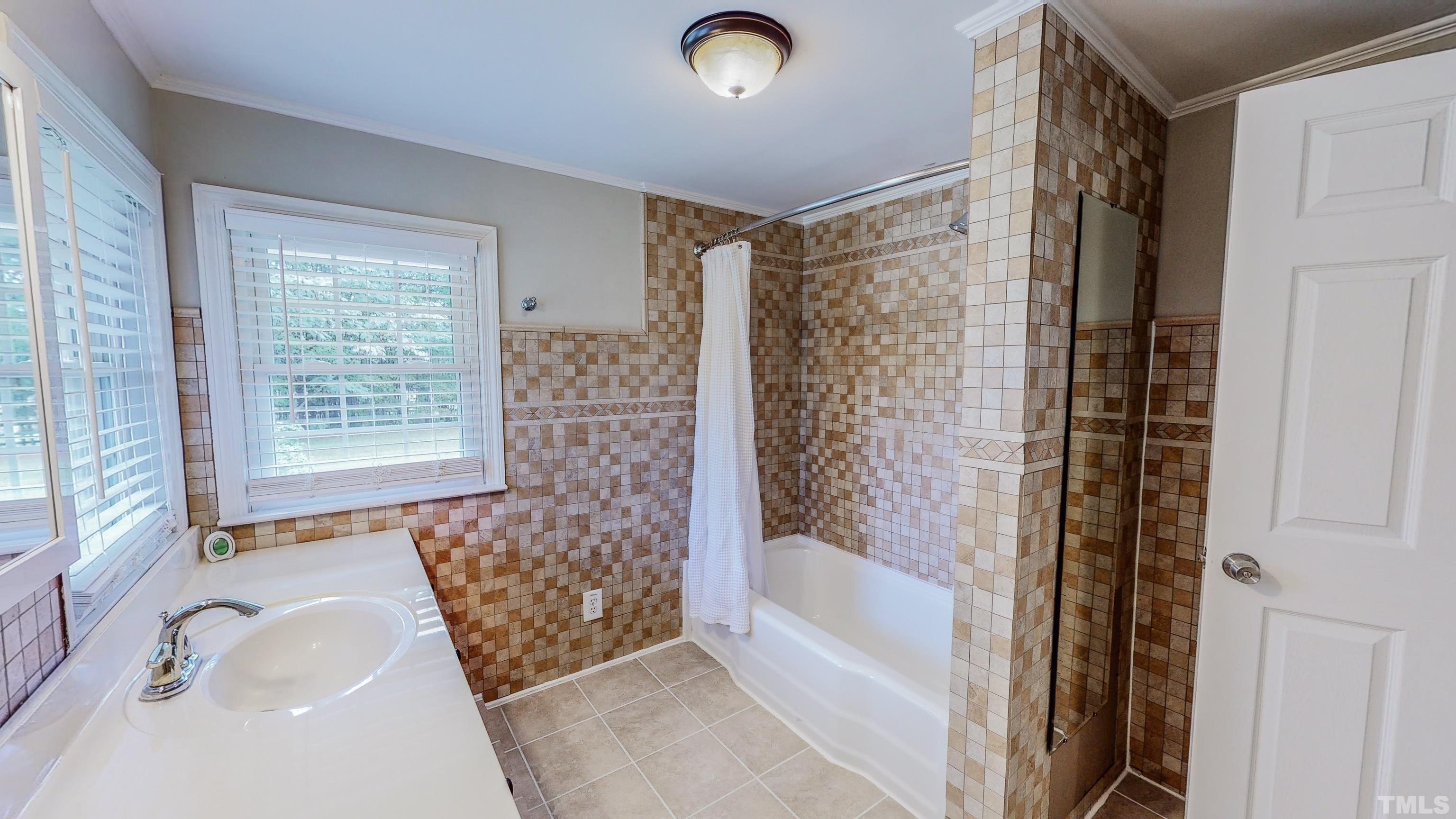 3920 Oxford Road Roxboro, NC 27574 - Photo 20 of 30 a bathroom with a bathtub and shower