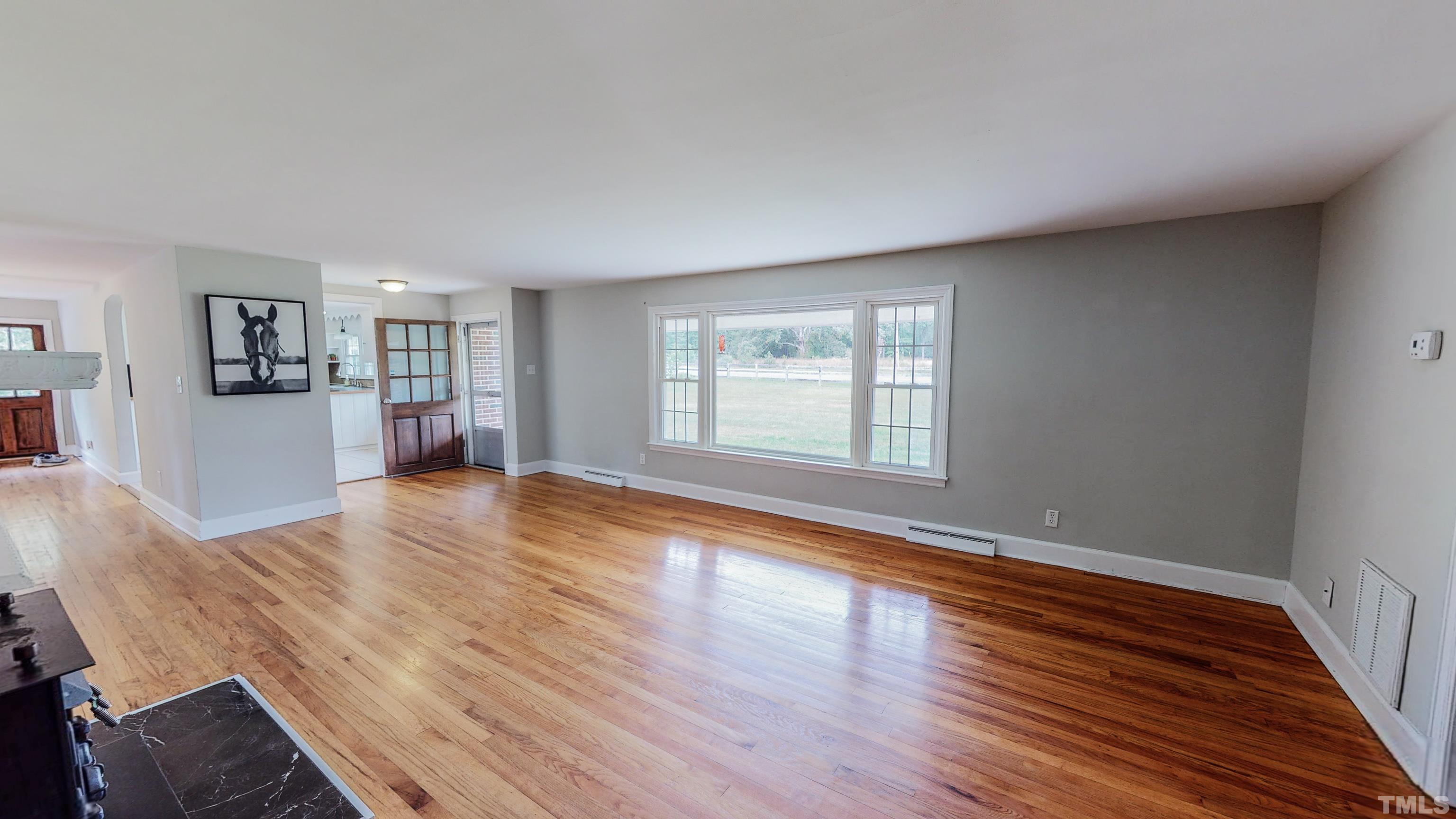 3920 Oxford Road Roxboro, NC 27574 - Photo 3 of 30 a view of empty room with wooden floor and window