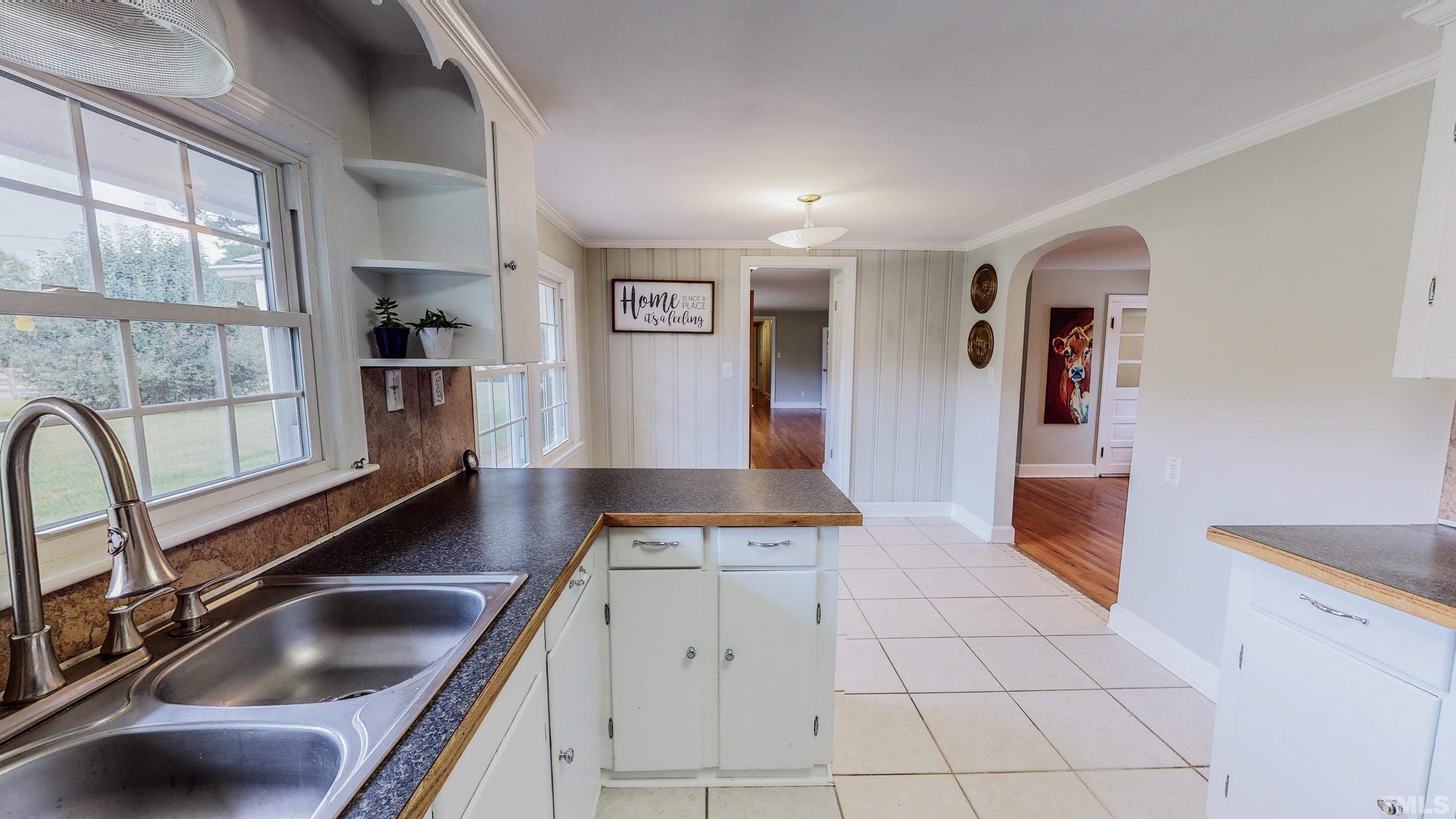 3920 Oxford Road Roxboro, NC 27574 - Photo 6 of 30 a kitchen with a sink a counter top space cabinets and stainless steel appliances