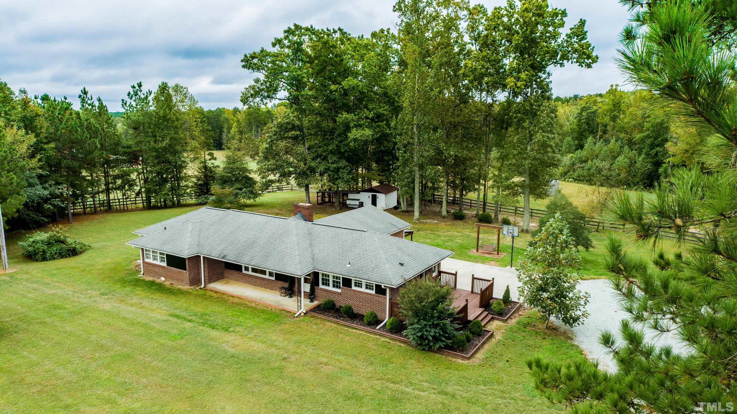 3920 Oxford Road Roxboro, NC 27574 - Photo 9 of 30 an aerial view of a house with garden space and street view