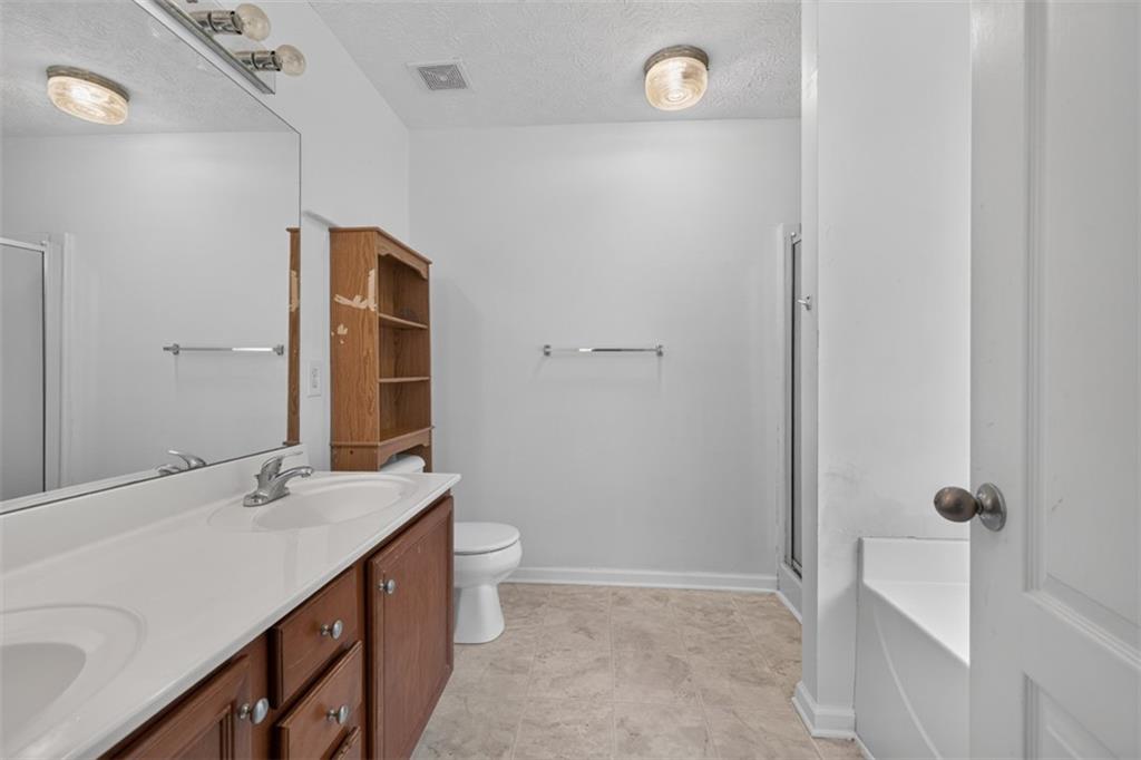 602 Pendergrass Road Winder, GA 30680 - Photo 26 of 44 a bathroom with a sink a toilet and shower