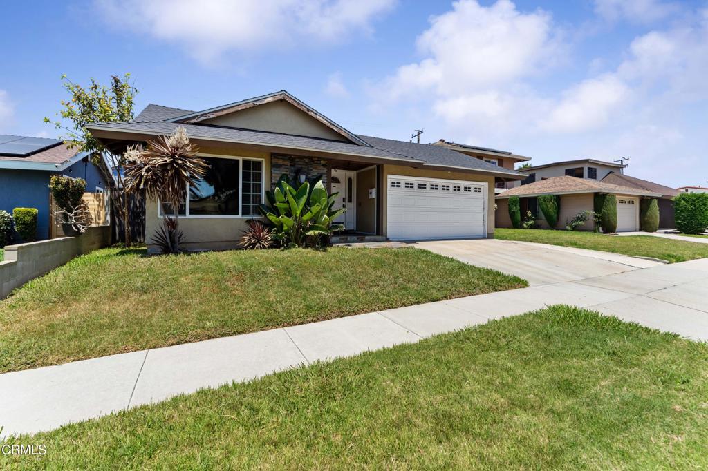 1421 East Abbottson Street Carson, CA 90746 - Photo 18 of 18 a front view of a house with a yard and garage