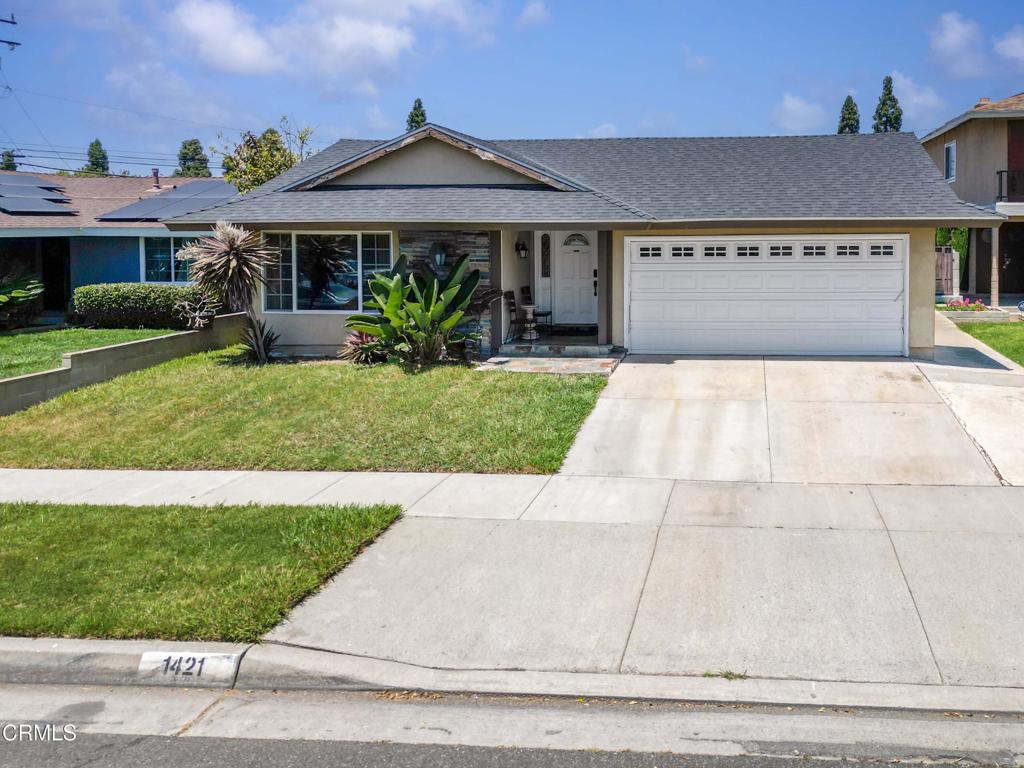 1421 East Abbottson Street Carson, CA 90746 - Photo 2 of 18 a front view of a house with a garden