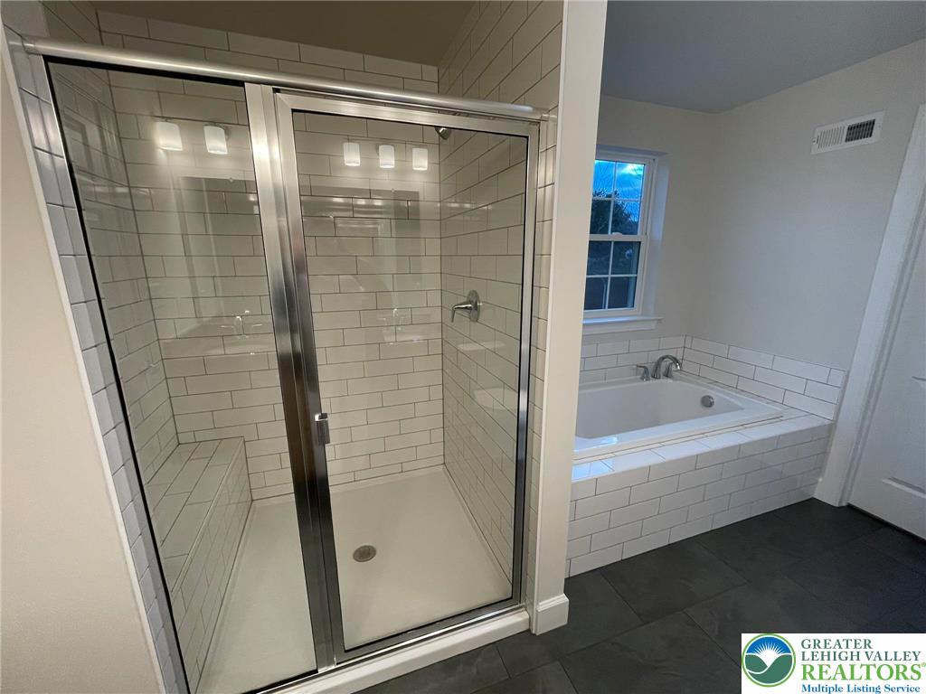 5043 Chapmans Road Orefield, PA 18069 - Photo 11 of 18 a bathroom with a bathtub and a shower