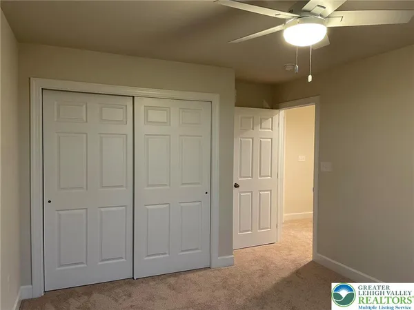 a bathroom with a granite countertop sink a toilet and a mirror