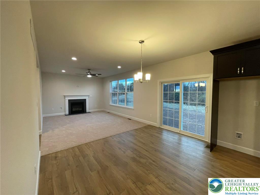 5043 Chapmans Road Orefield, PA 18069 - Photo 5 of 18 a view of an empty room with wooden floor and a window