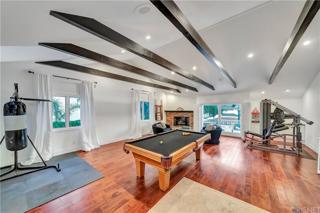 22963 Cass Avenue Woodland Hills, CA 91364 - Photo 12 of 66 a living room with furniture a wooden floor and next to a window