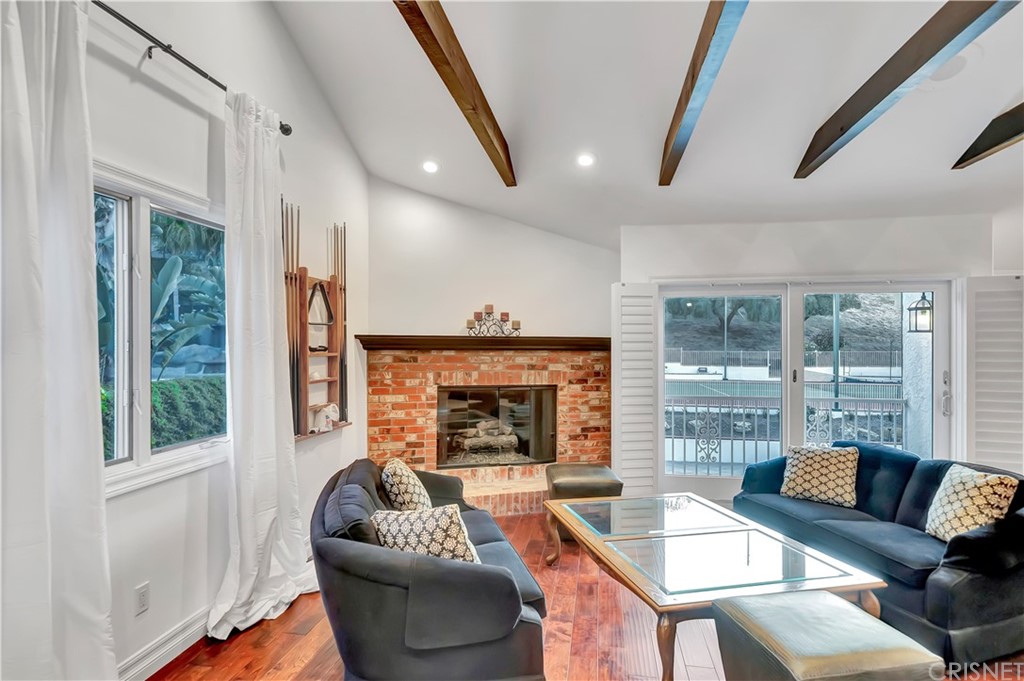 22963 Cass Avenue Woodland Hills, CA 91364 - Photo 15 of 66 a living room with furniture and a fireplace