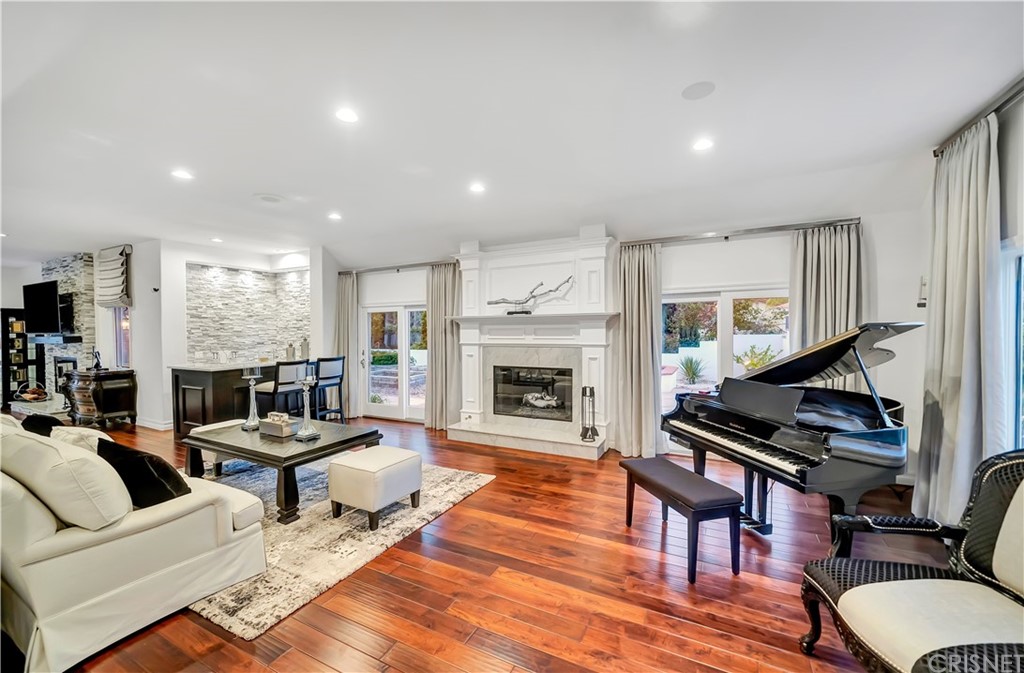 22963 Cass Avenue Woodland Hills, CA 91364 - Photo 20 of 66 a living room with furniture fireplace and a fireplace