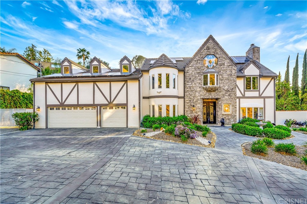 22963 Cass Avenue Woodland Hills, CA 91364 - Photo 22 of 66 a front view of a house with a garden