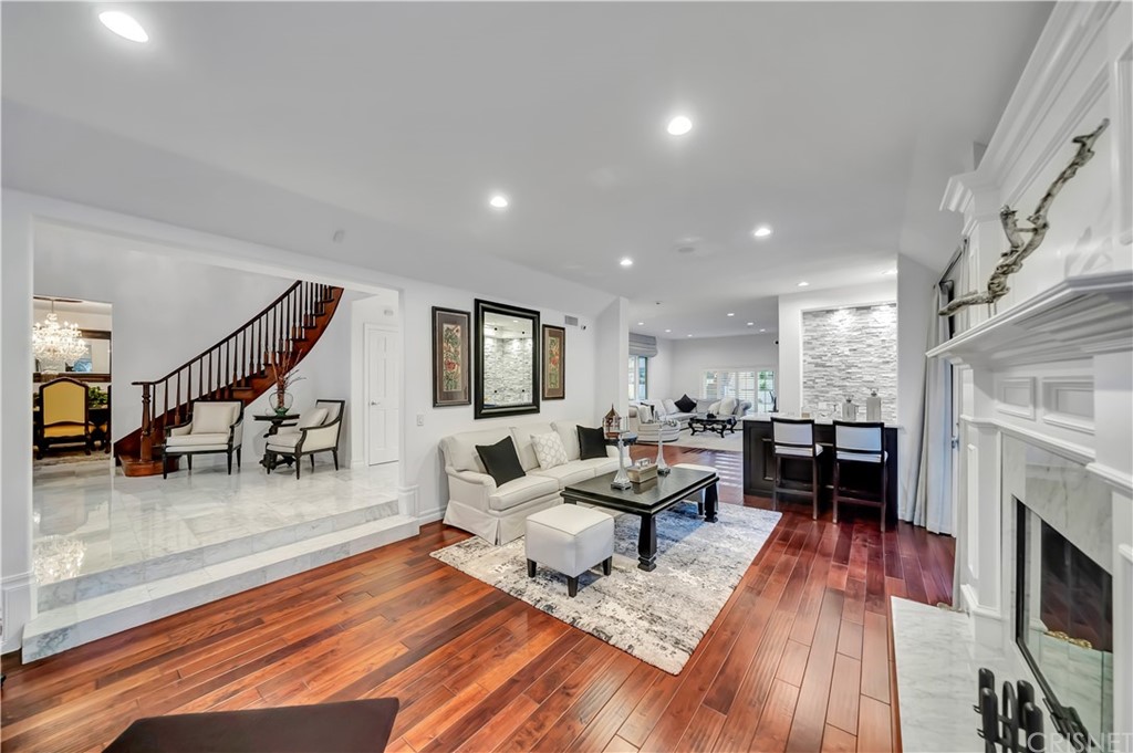 22963 Cass Avenue Woodland Hills, CA 91364 - Photo 29 of 66 a living room with furniture and a fireplace