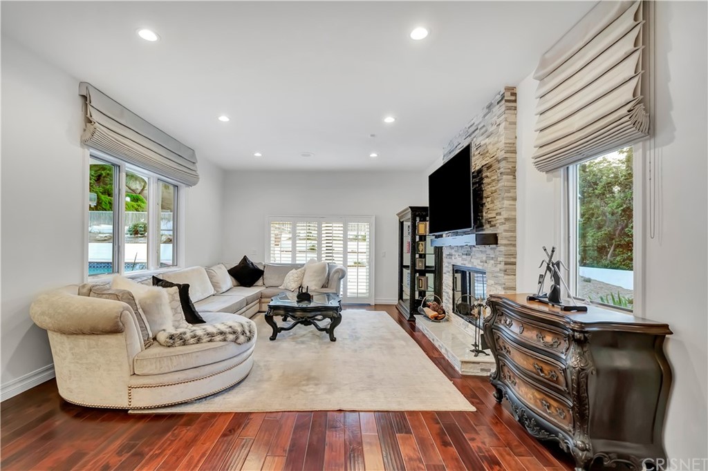 22963 Cass Avenue Woodland Hills, CA 91364 - Photo 30 of 66 a living room with fireplace furniture and a flat screen tv