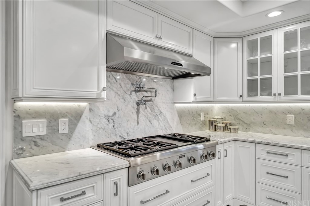 22963 Cass Avenue Woodland Hills, CA 91364 - Photo 34 of 66 a white stove top oven sitting inside of a kitchen
