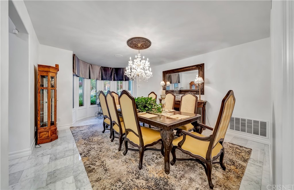 22963 Cass Avenue Woodland Hills, CA 91364 - Photo 36 of 66 a view of a dining room with furniture and window
