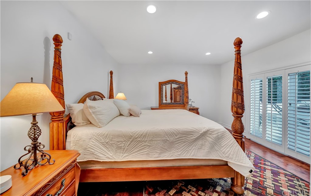 22963 Cass Avenue Woodland Hills, CA 91364 - Photo 41 of 66 a bedroom with a bed and a window