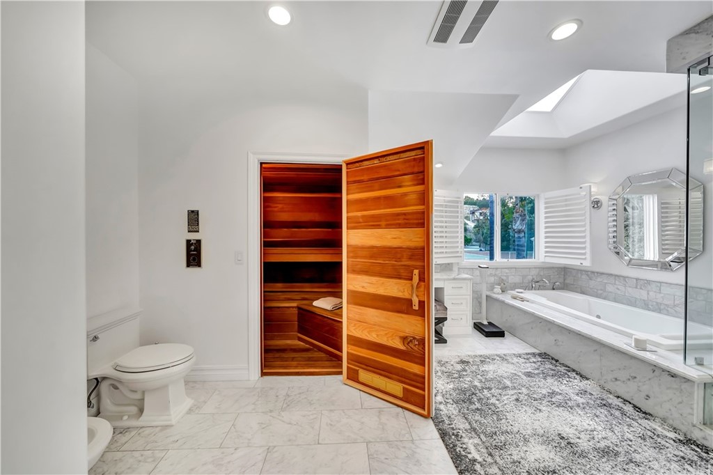 22963 Cass Avenue Woodland Hills, CA 91364 - Photo 9 of 66 a bathroom with a toilet a sink and bathtub
