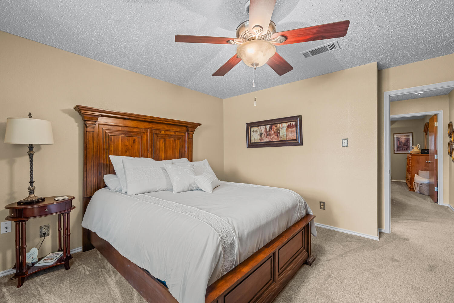 1500 West Lynn Street Slaton, TX 79364 - Photo 20 of 37 a bedroom with a bed and a chandelier