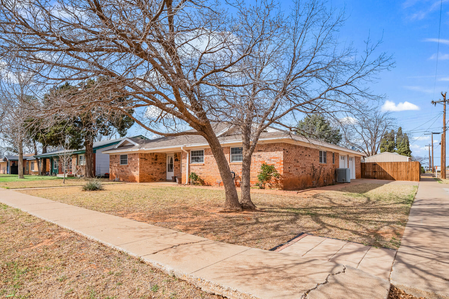 1500 West Lynn Street Slaton, TX 79364 - Photo 2 of 37 a front view of a house with a yard covered in snow