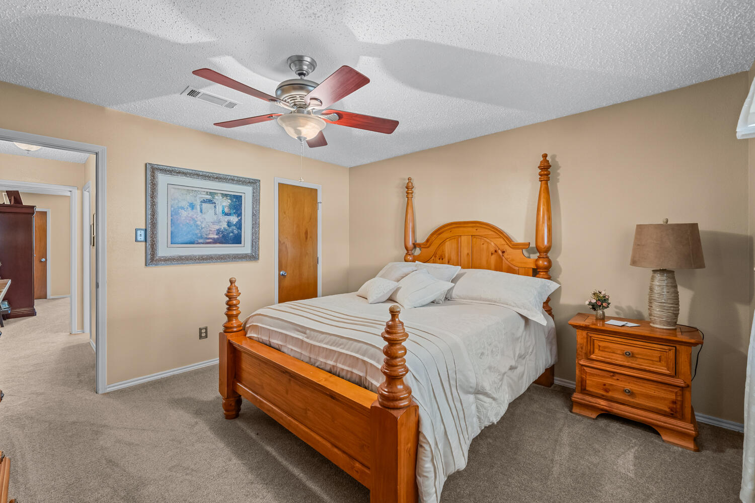 1500 West Lynn Street Slaton, TX 79364 - Photo 22 of 37 a bedroom with a bed and a chandelier