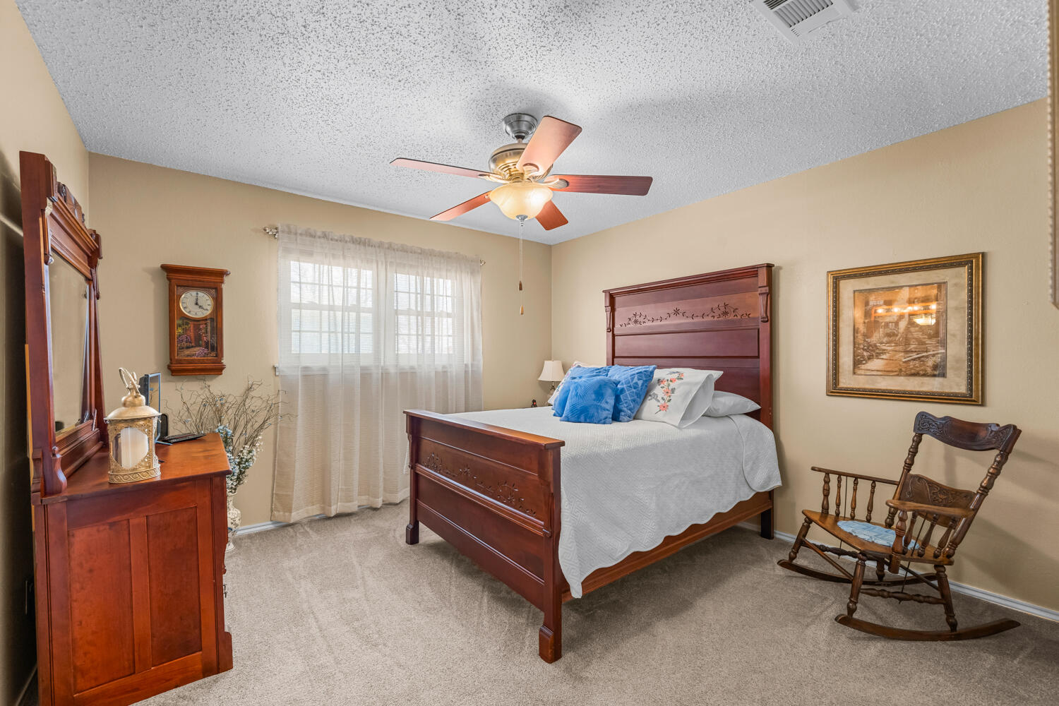 1500 West Lynn Street Slaton, TX 79364 - Photo 23 of 37 a bed room with a bed and a chandelier