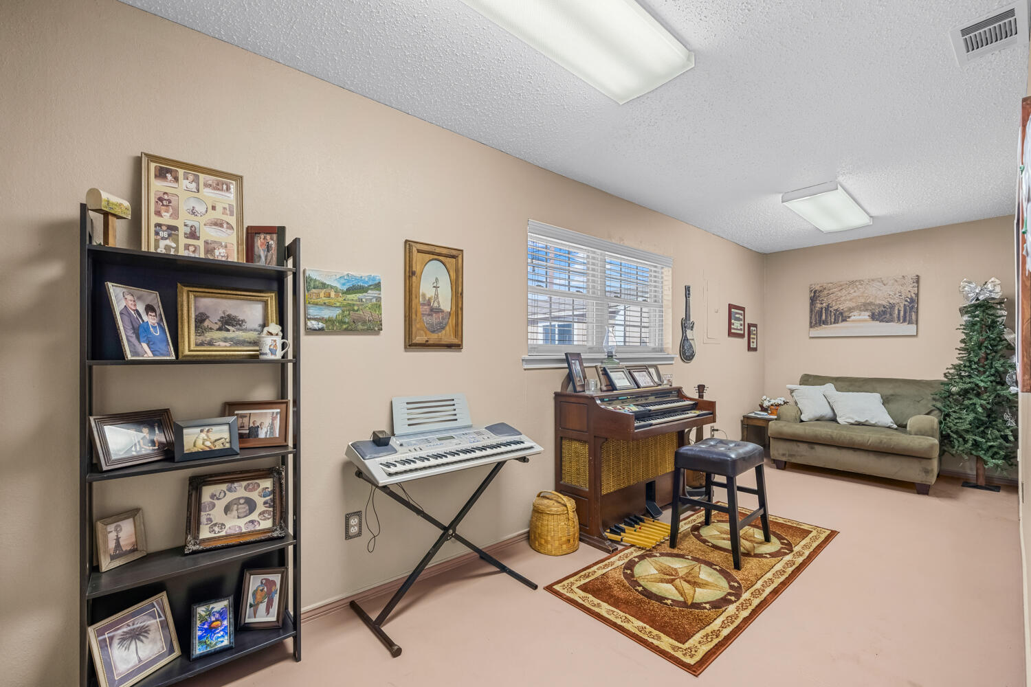 1500 West Lynn Street Slaton, TX 79364 - Photo 27 of 37 a living room with furniture a bookshelf and a window