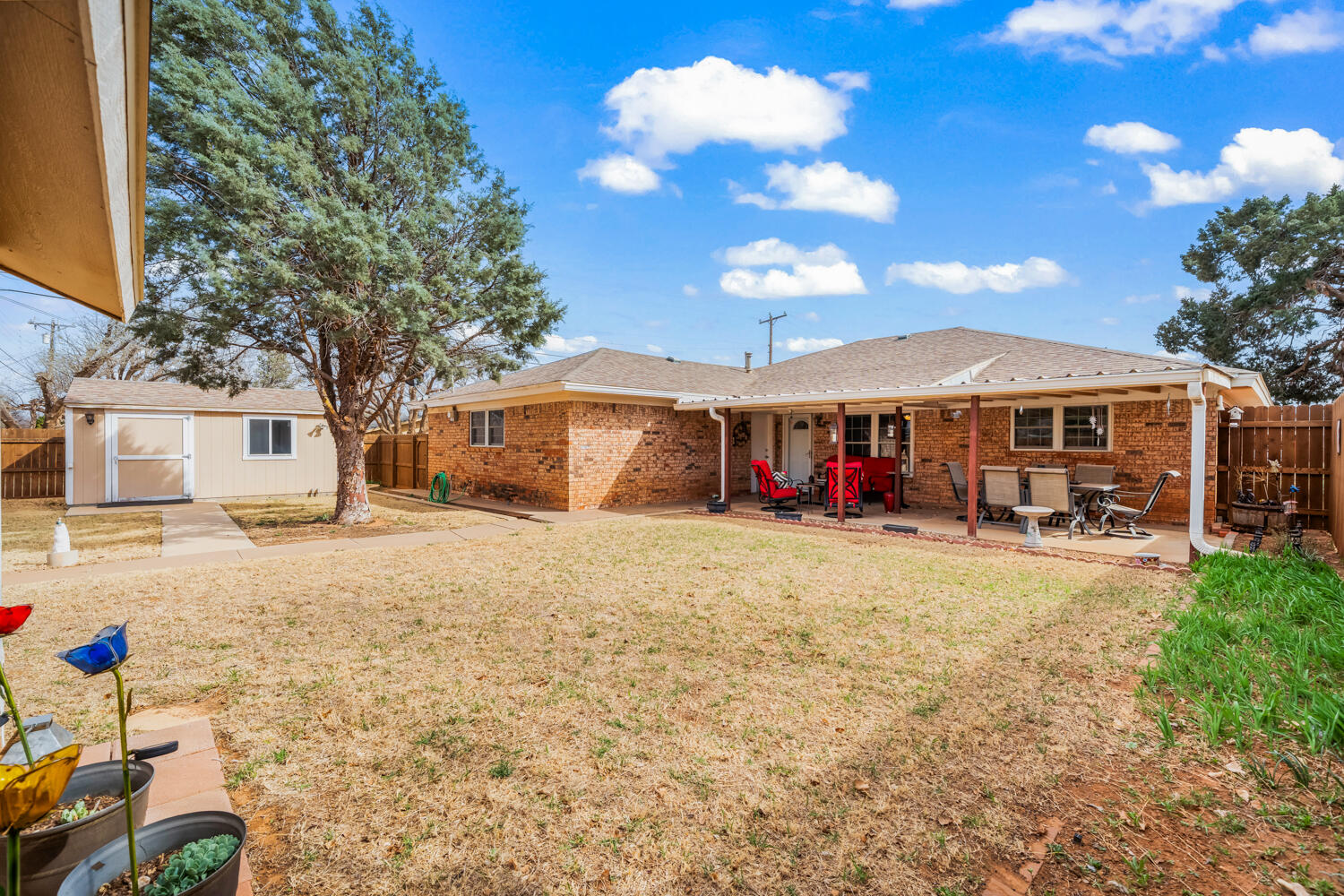 1500 West Lynn Street Slaton, TX 79364 - Photo 31 of 37 a view of a house with backyard and sitting area