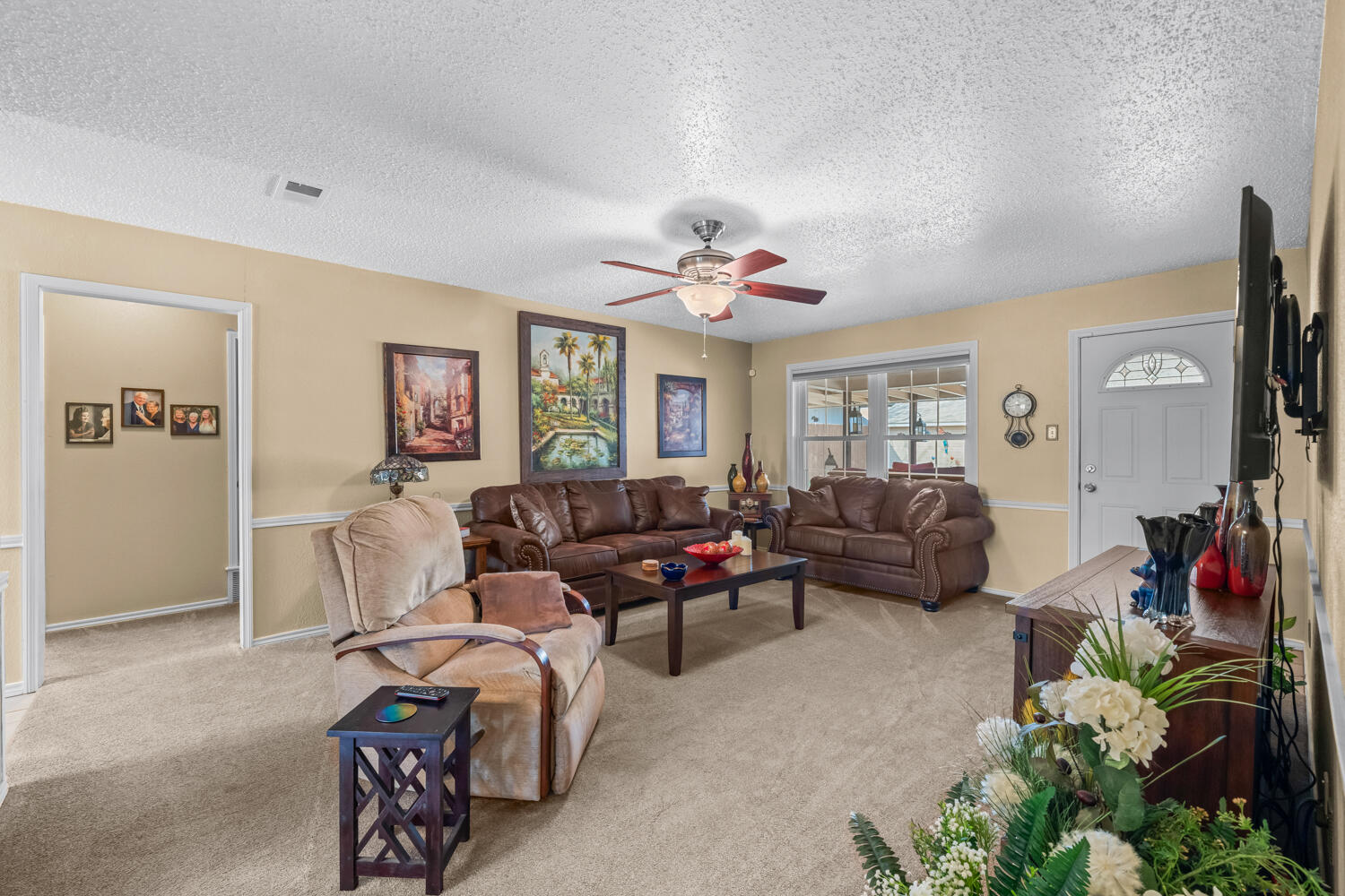 1500 West Lynn Street Slaton, TX 79364 - Photo 5 of 37 a living room with furniture and a flat screen tv