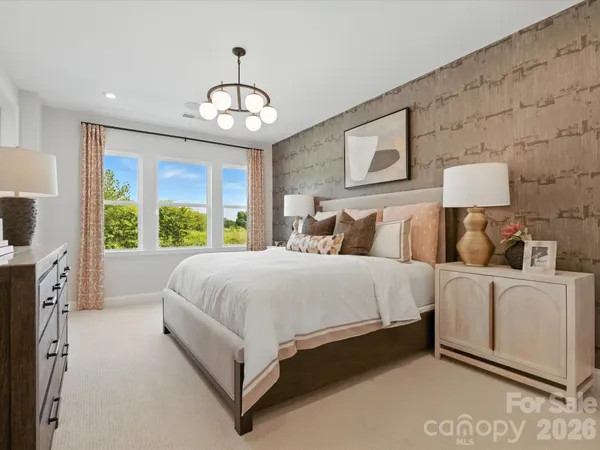 a bed room with a bed and a large window