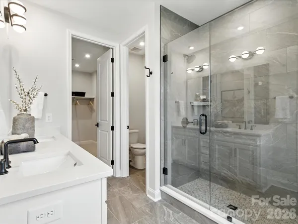 a bathroom with a shower sink and mirror