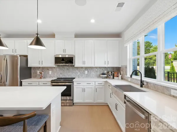 a kitchen with a sink a stove a refrigerator and a stove