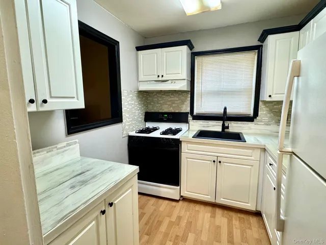 a kitchen with a sink stove and refrigerator