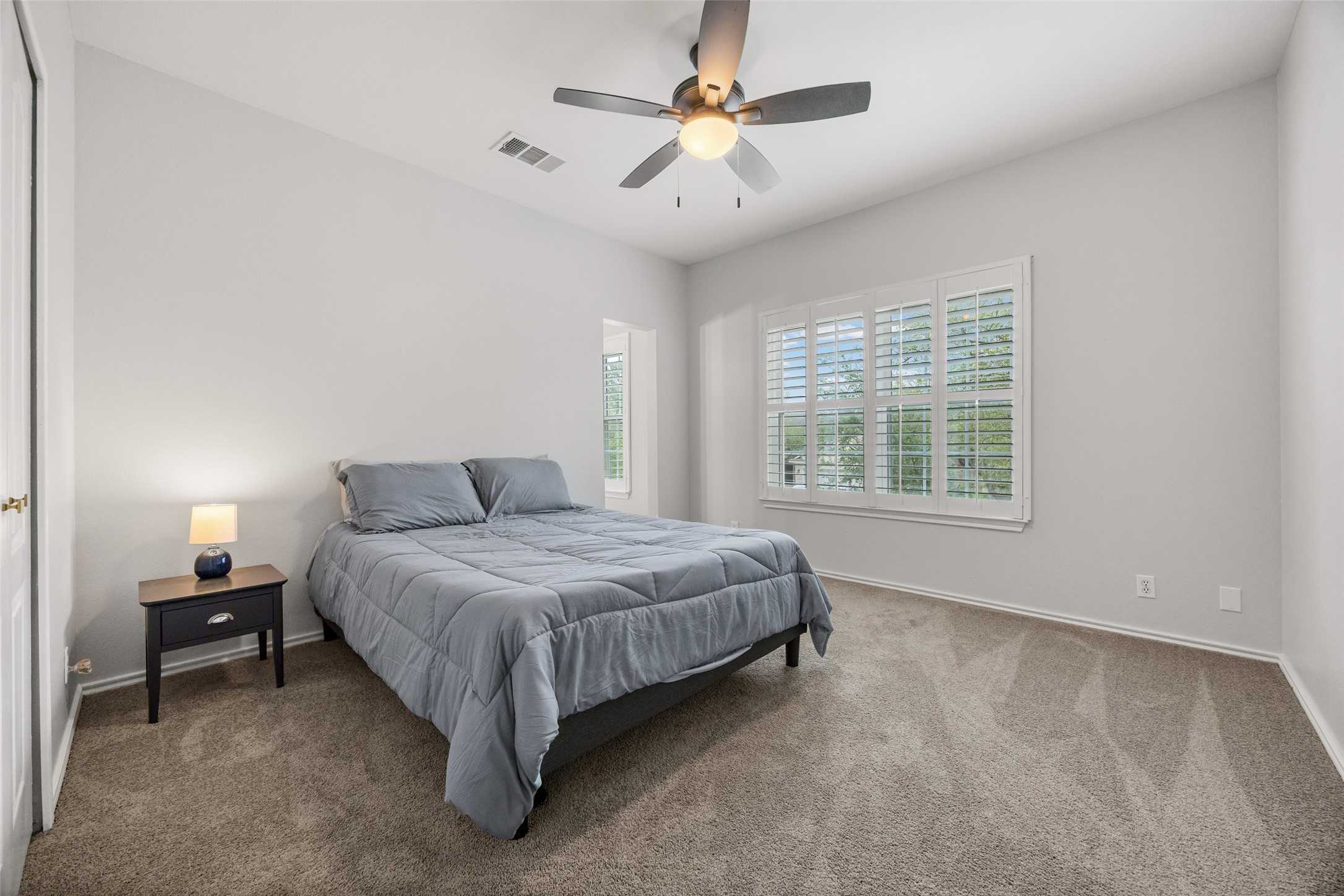 8610 Axis Drive Austin, TX 78749 - Photo 19 of 29 a spacious bedroom with a bed and a chandelier