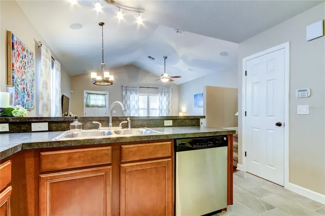 a kitchen with stainless steel appliances granite countertop a sink a refrigerator and a granite counter tops