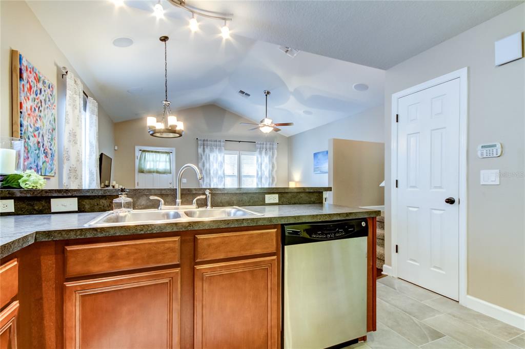 2123 West Spruce Street Tampa, FL 33607 - Photo 12 of 40 a kitchen with stainless steel appliances granite countertop a sink a refrigerator and a granite counter tops