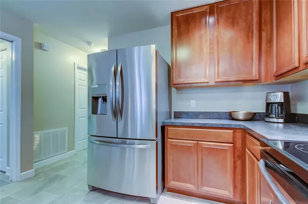 a kitchen with a refrigerator sink and cabinets