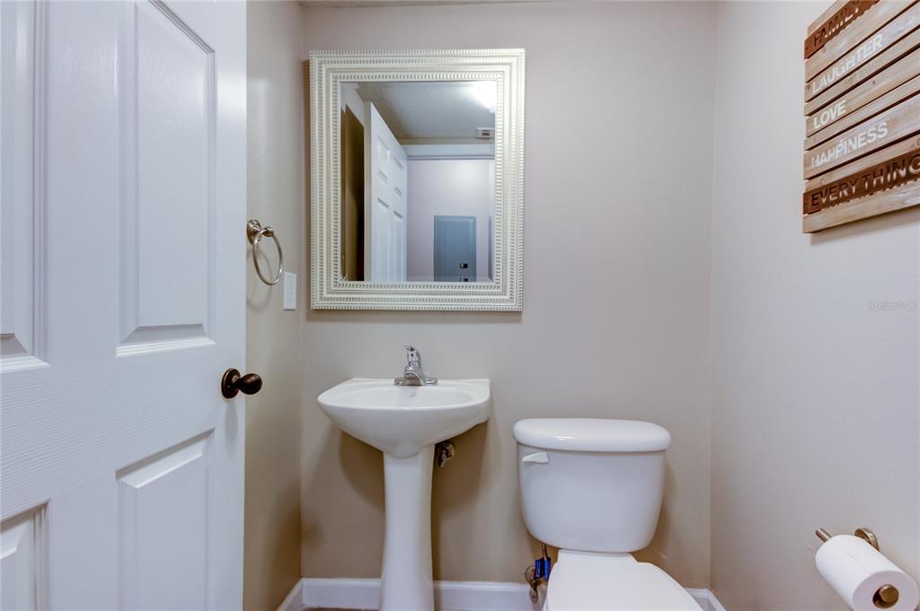 2123 West Spruce Street Tampa, FL 33607 - Photo 16 of 40 a bathroom with a toilet sink and mirror