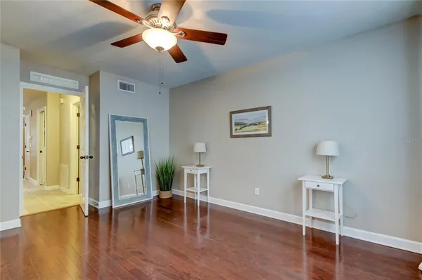 a view of empty room with wooden floor