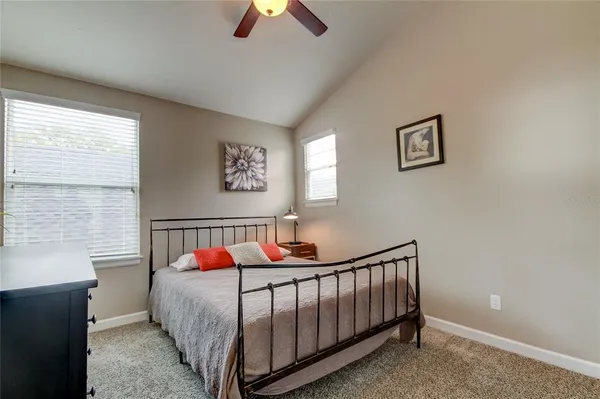a bed sitting in a bedroom next to a window