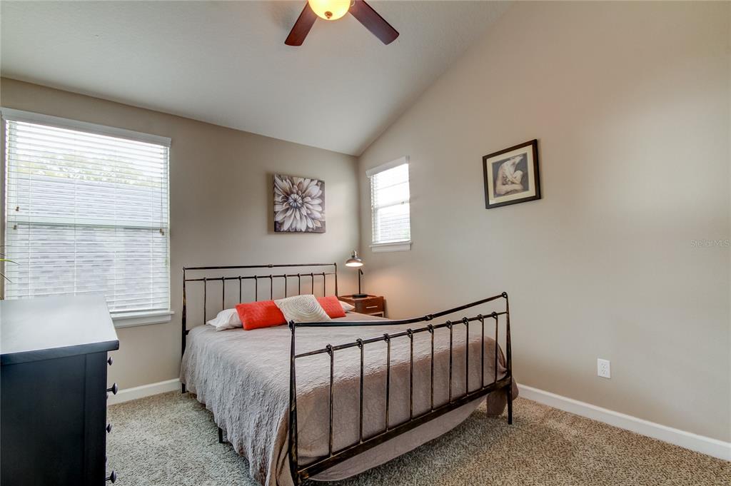 2123 West Spruce Street Tampa, FL 33607 - Photo 24 of 40 a bed sitting in a bedroom next to a window