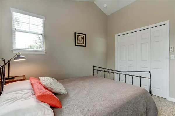 a bedroom with a bed and a window