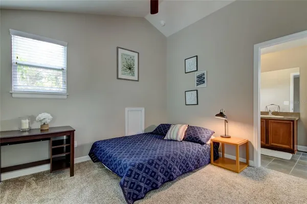 a bedroom with a bed and a table in it