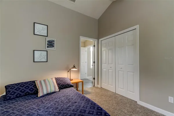 a bedroom with a bed and a couch