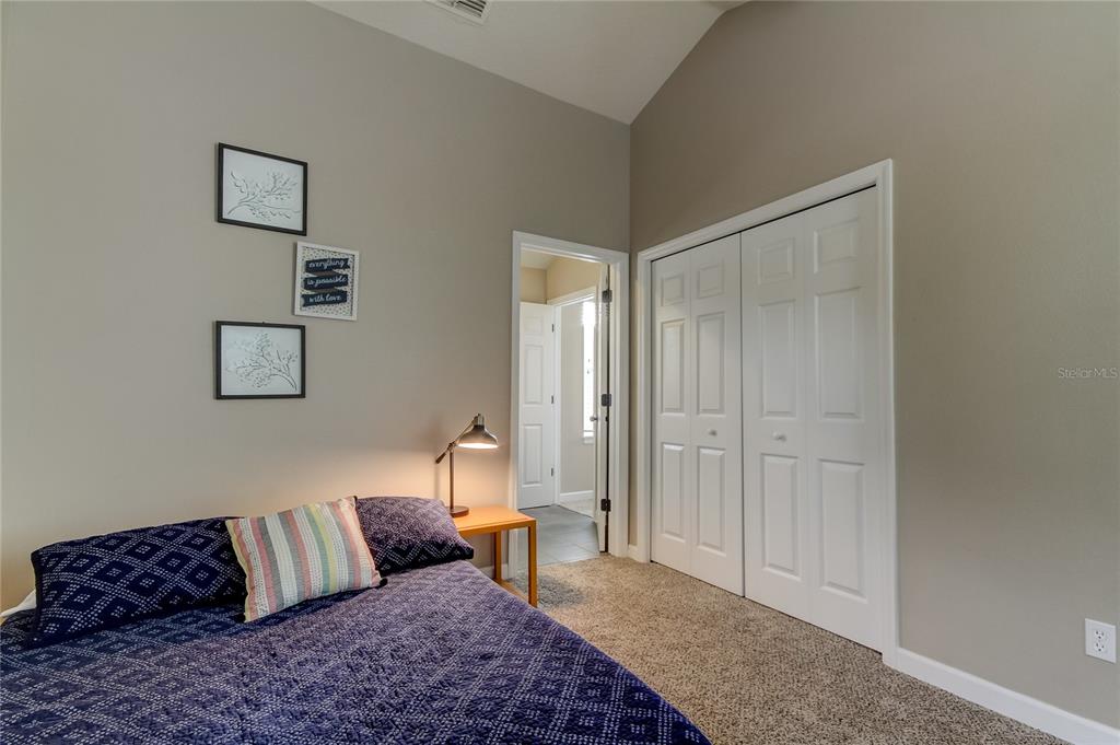 2123 West Spruce Street Tampa, FL 33607 - Photo 32 of 40 a bedroom with a bed and a couch